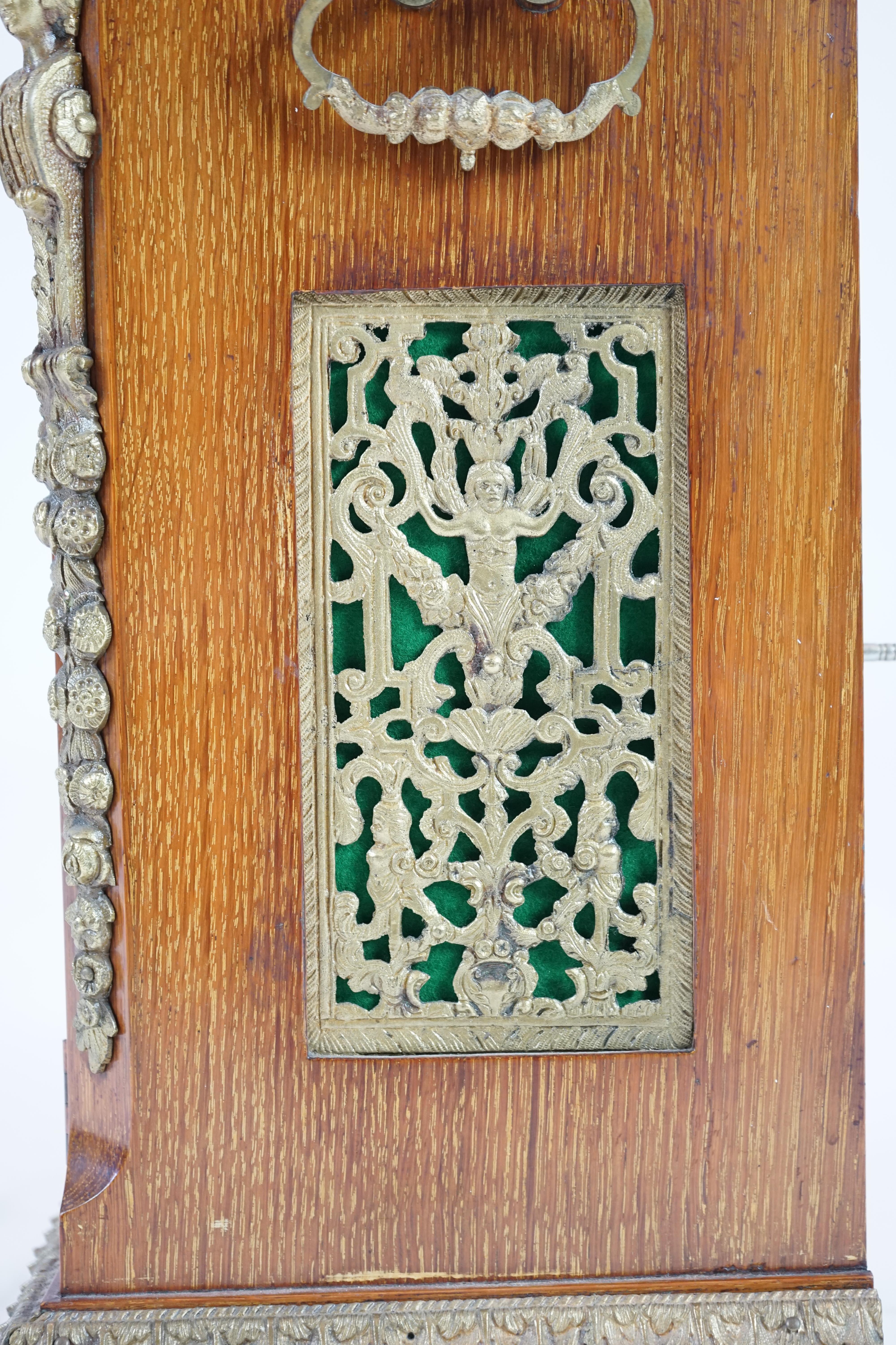 A late Victorian ormolu mounted golden oak cased eight day chiming bracket clock and bracket